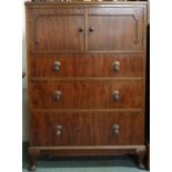 An early 20th century mahogany bedroom tallboy chest with pair of cabinet doors over three drawers