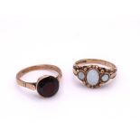 A 9ct gold opal ring, size N1/2, a 9ct gold garnet ring, size O, weight together 5.6gms Condition
