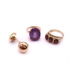 A 9ct gold three stone garnet ring, size Q, together with a yellow metal faux amethyst ring weight