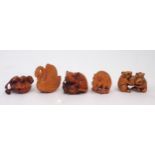 A collection of Japanese fruitwood netsuke, one carved as a swan, the other as a monkey clutching