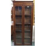 A Victorian walnut veneered glazed two door shallow bookcase, 164cm high x 76cm wide x 27cm deep