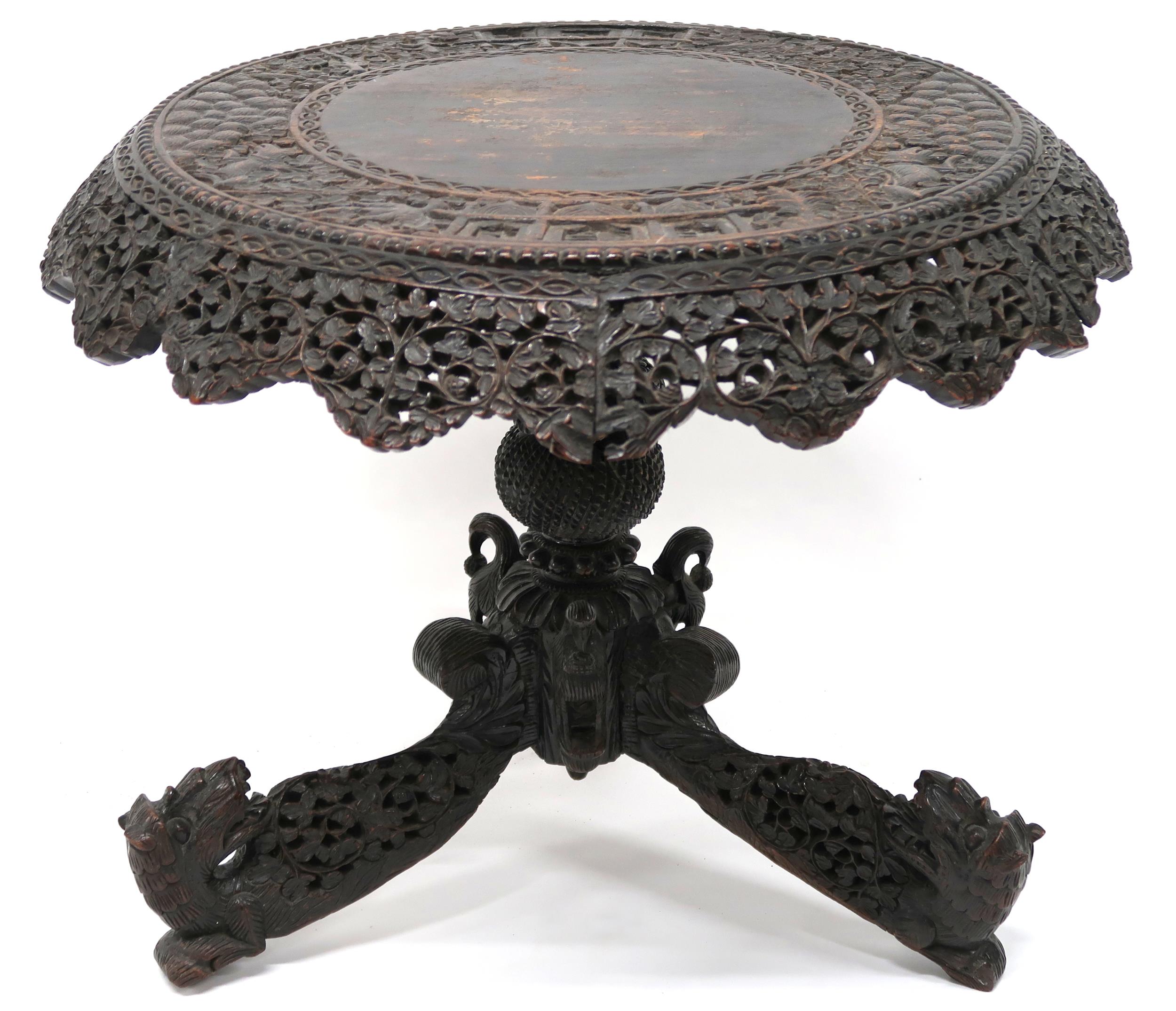 AN ANGLO-INDIAN TILT TOP CIRCULAR TABLE with extensively pierced carved foliate table apron over