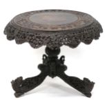 AN ANGLO-INDIAN TILT TOP CIRCULAR TABLE with extensively pierced carved foliate table apron over