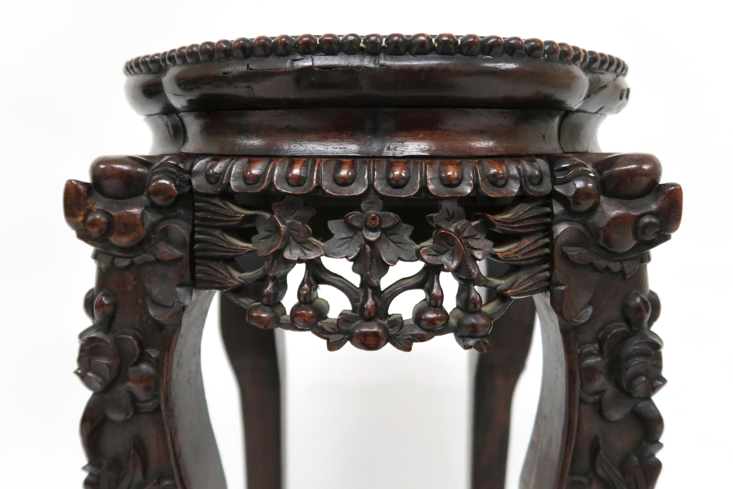 A CHINESE HARDWOOD JARDINERE STAND  with shaped top inset with pink marble over floral carved - Image 2 of 9