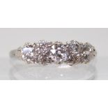 AN OLD CUT DIAMOND CLUSTER RING mounted throughout in white metal and set with estimated approx 0.