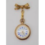 A 14K GOLD OPEN FACE FOB WATCH with a decorative French gold transfer patterned dial & blue Roman