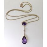 A 15CT AMETHYST & DIAMOND NECKLET set with a 15mm x 10mm pear-shaped amethyst, a further oval cut