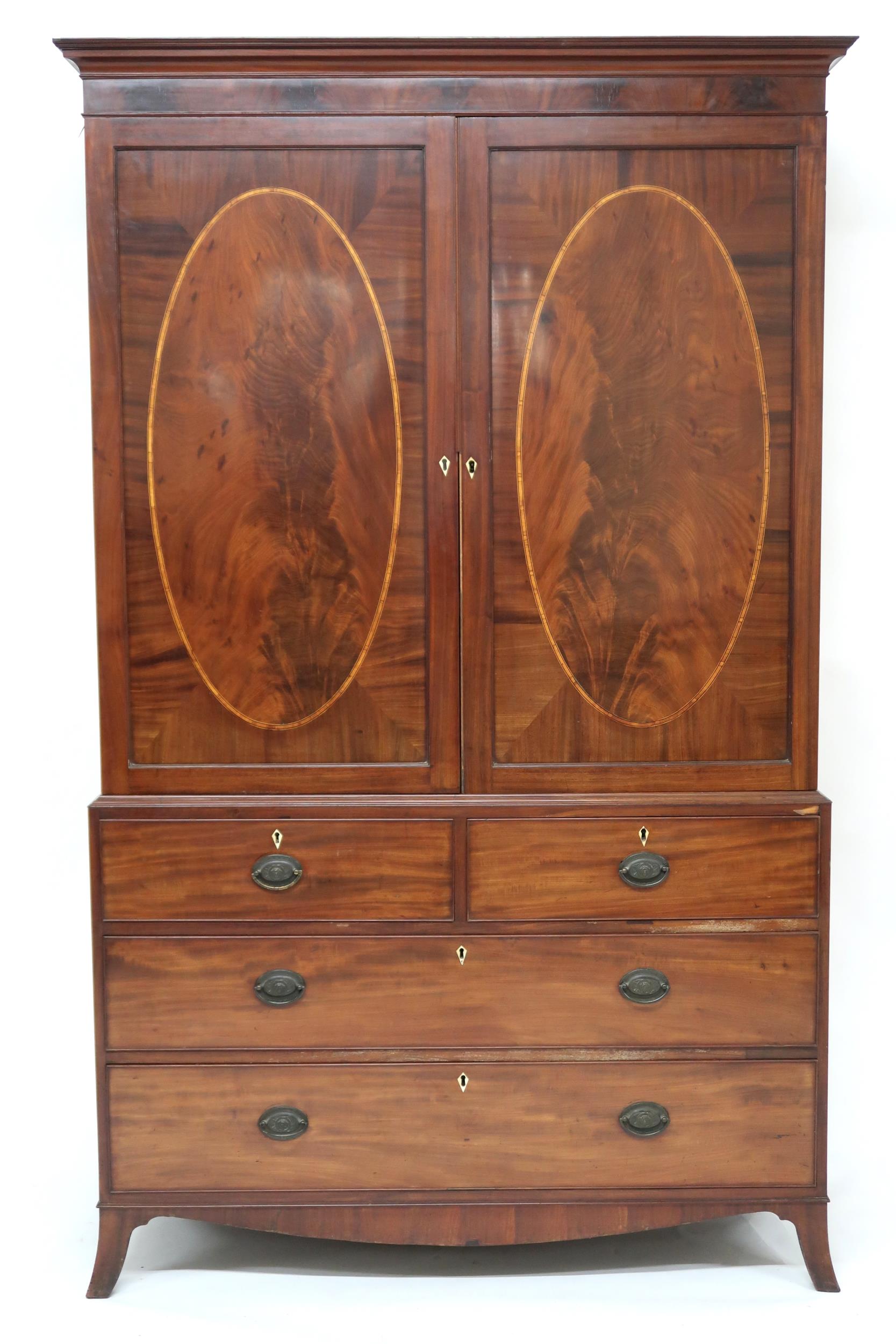 A GEORGIAN MAHOGANY LINEN PRESS  with moulded cornice over pair of satinwood inlaid panel doors