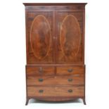 A GEORGIAN MAHOGANY LINEN PRESS  with moulded cornice over pair of satinwood inlaid panel doors