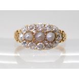 A PEARL AND OLD CUT DIAMOND RING with a pretty pierced gallery and shoulders in 18ct gold, set