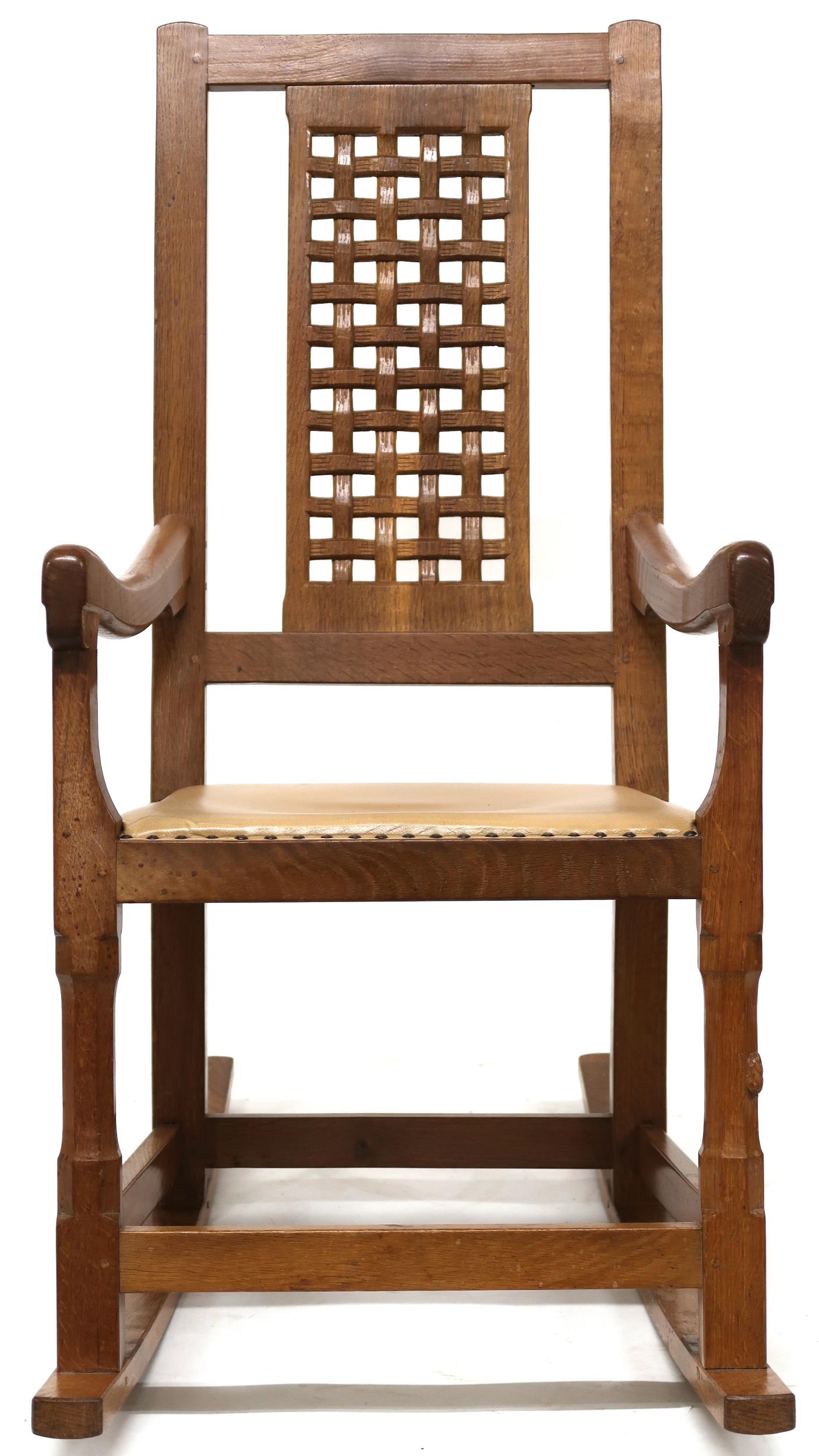 A PETER "RABBITMAN" HEAP OAK LATTICE BACK ROCKING CHAIR with carved lattice splat over beige leather