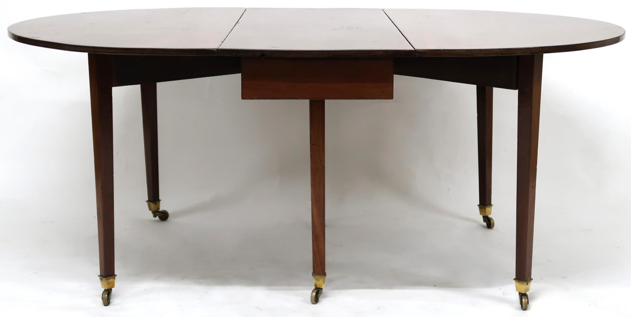 A VICTORIAN MAHOGANY DROPLEAF TABLE  with oval drop leaf top on square tapering supports terminating