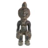 A CARVED HARDWOOD FEMALE FIGURE, CONGO Augmented with fabric-covered grass banding, measuring