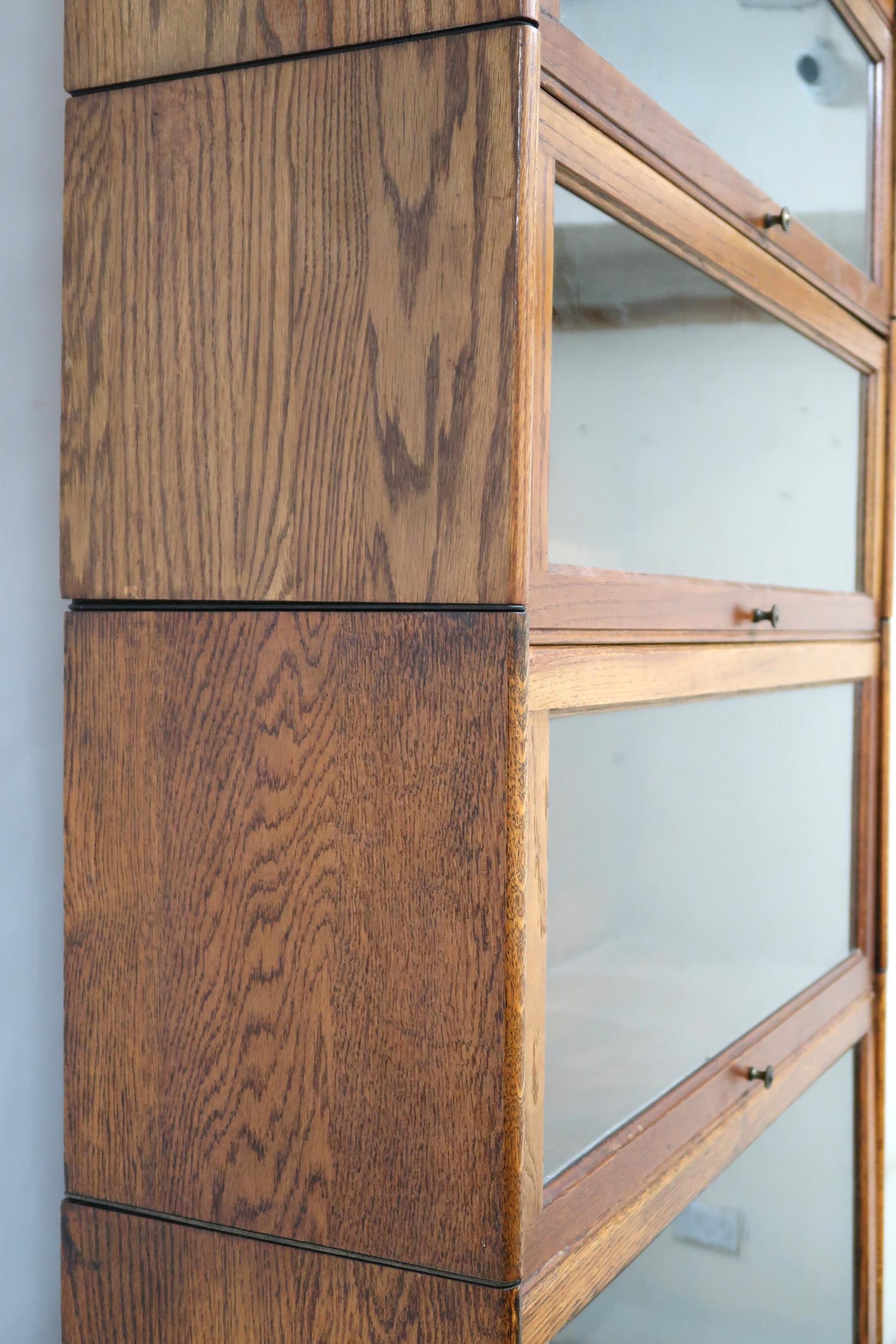 AN EARLY 20TH CENTURY OAK GLOBE-WERNICKE STYLE SIX TIER SECTIONAL BOOKCASE with six glazed doored - Image 13 of 13