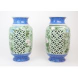 A PAIR OF JAPANESE CELADON RETICULATED VASES each moulded in relief and painted with birds and