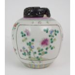 A CHINESE FAMILLE ROSE JAR  Painted with panels of flowers and scattered flowers, 18cm high