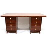 A LATE 20TH CENTURY ART DECO STYLE TWIN PEDESTAL DESK with shaped top on pair of four