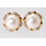 18CT GOLD MABE PEARL EARRINGS further set with diamond details to the leaf pattern mounts, mabe