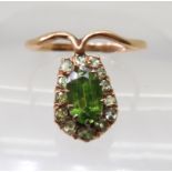 A RUSSIAN GOLD DEMANTOID GARNET RING in an early 20th Century style, the central demantoid garnet