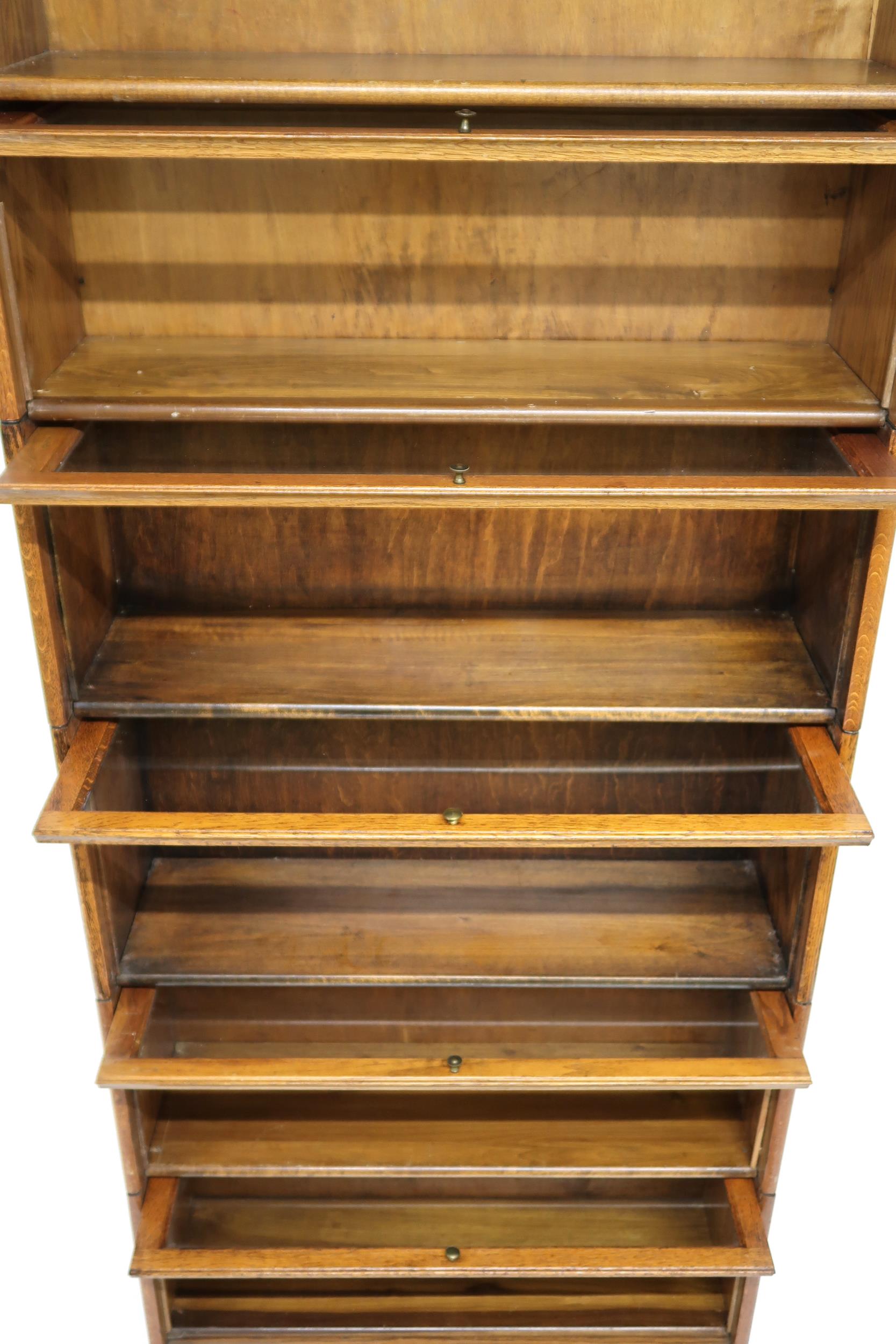 AN EARLY 20TH CENTURY OAK GLOBE-WERNICKE STYLE SIX TIER SECTIONAL BOOKCASE with six glazed doored - Image 8 of 13