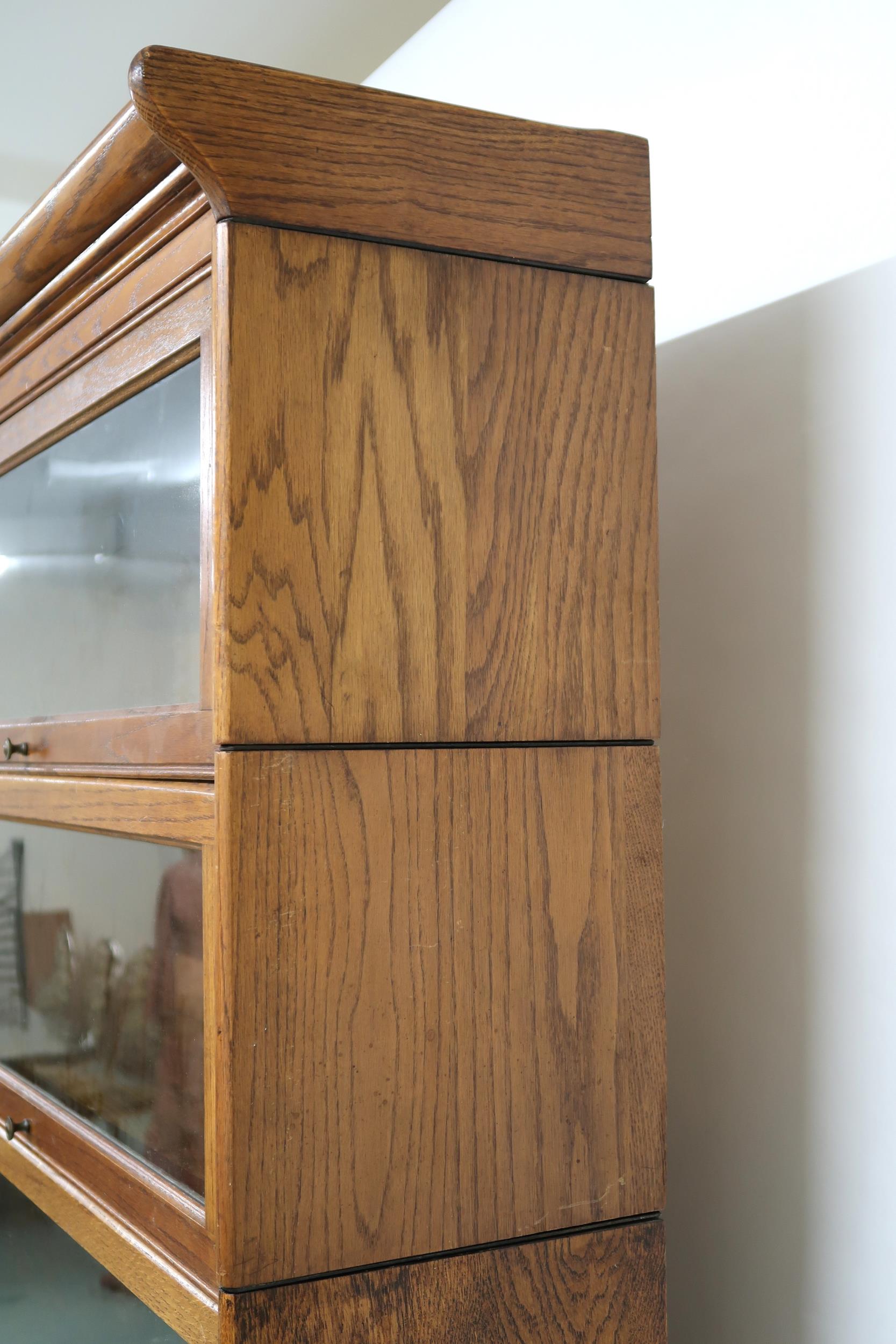 AN EARLY 20TH CENTURY OAK GLOBE-WERNICKE STYLE SIX TIER SECTIONAL BOOKCASE with six glazed doored - Image 11 of 13