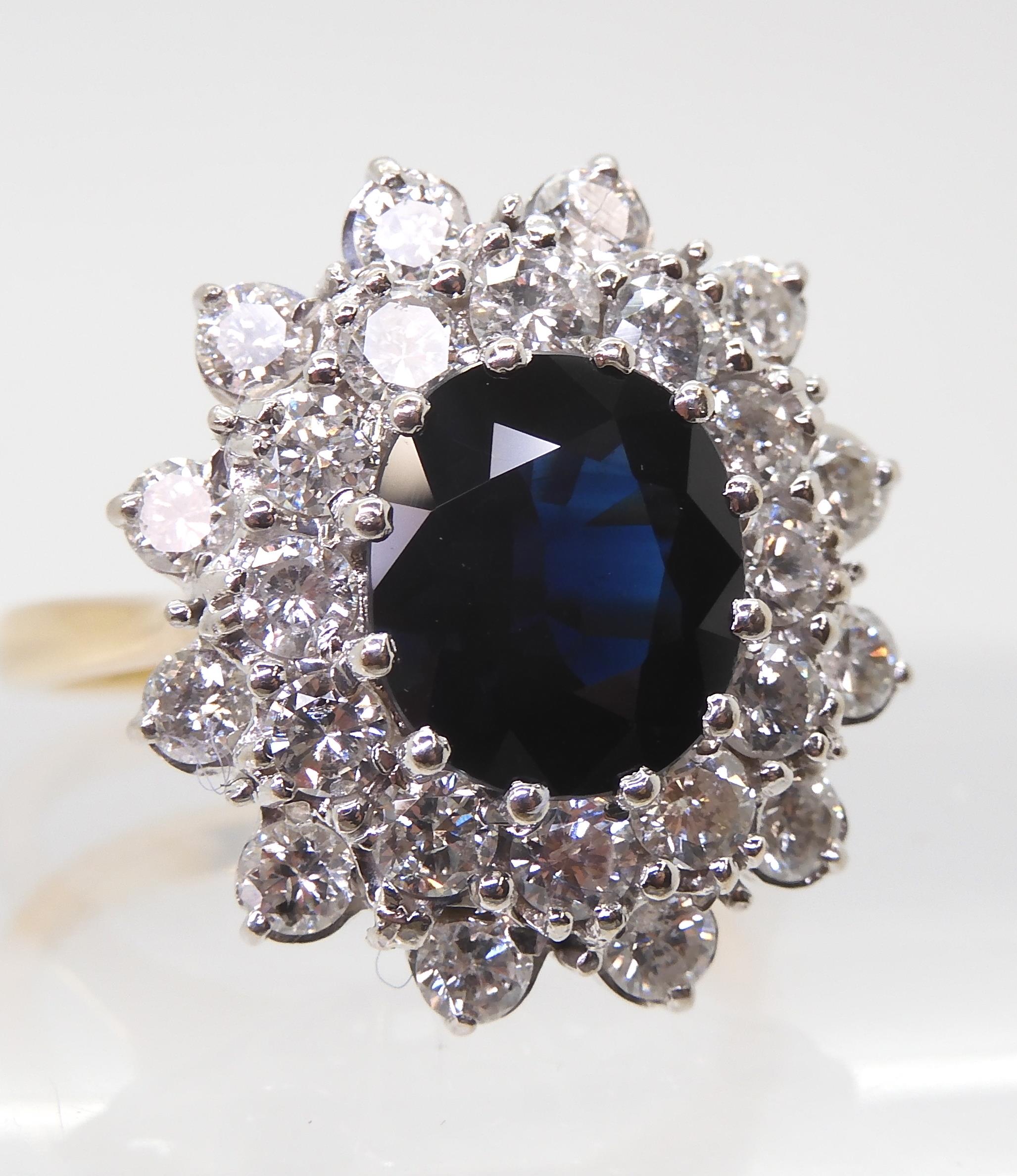 A SAPPHIRE AND DIAMOND CLUSTER RING the 16.8mm x 18mm cluster, mounted throughout in yellow and - Image 3 of 8