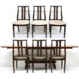 A MID-20TH CENTURY STAINED TEAK DANISH OVERSEAS FURNITURE EXTENDING DINING TABLE AND SIX CHAIRS