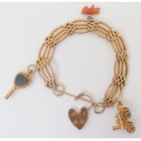 A 9CT GOLD GATE BRACELET with a heart-shaped clasp, heart shaped agate and crystal-shaped watch key,