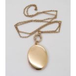 A MEMORIAL LOCKET made in yellow metal, the oval case is not engraved on the outside, inside it is