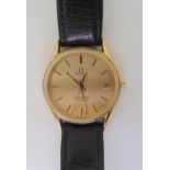 AN OMEGA SEAMASTER QUARTZ with a gold plated case, gold coloured dial with baton numerals and hands,