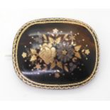 A PIQUE WEAR FLORAL BROOCH the tortoise shell inlaid with different coloured metal flowers,