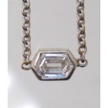 A DIAMOND SOLITAIRE PENDANT set with an unusual octagonal cut diamond with an estimated approx carat