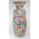 A CANTON FAMILLE ROSE VASE  Painted with panels of mandarins holding court with attendants,