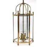 AN EARLY 20TH CENTURY BRASS HEXAGONAL HALLWAY LANTERN with scroll top suspending