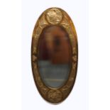 A GLASGOW SCHOOL CELTIC REVIVAL WALL MIRROR of oval form with knotwork decoration, 85cm long