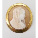 A 9CT GOLD MOUNTED SHELL CAMEO craftsman carved with the Virgin Mary, in a 9ct gold brooch mount.