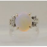 AN OPAL AND DIAMOND RING mounted throughout in 18ct white gold, the oval opal is approx 11.3mm x 9.