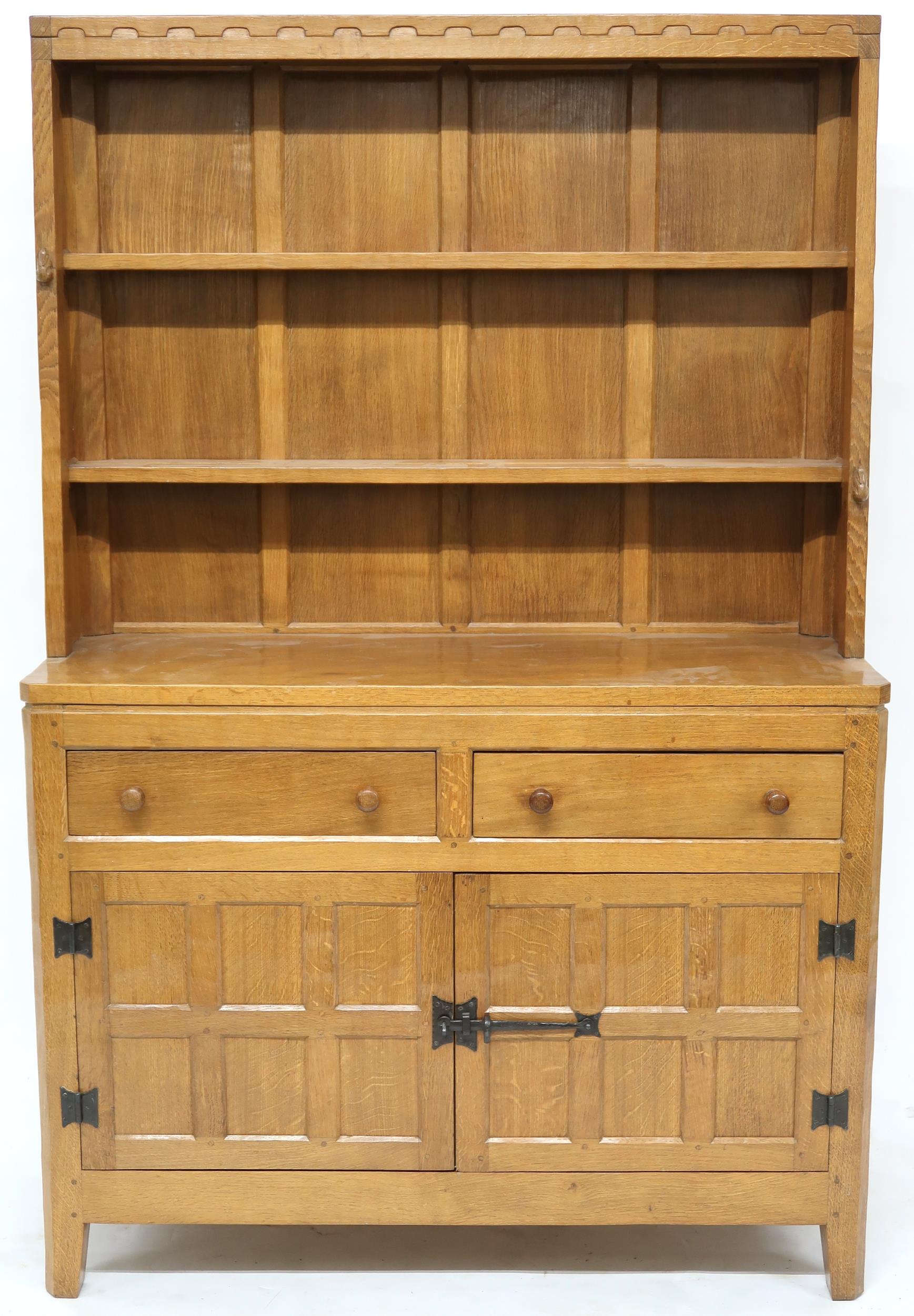 A PETER "RABBITMAN" HEAP OAK KITCHEN DRESSER with cornice carved with key design over two open plate