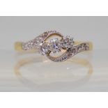 A VINTAGE THREE STONE RING set in 18ct gold and platinum the three diamonds have an estimated