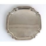 A GEORGE VI SILVER CARD TRAY by Emile Viner, Sheffield 1937, of shaped square form, on scroll