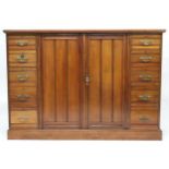A LATE VICTORIAN MAHOGANY LINEN PRESS  with pair of panel doors concealing four linen drawers