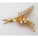 A 9CT GOLD FERN BROOCH set with five pearls, stamped with the makers mark A&W, dimensions 4.5cm x