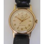 A 9CT GOLD TUDOR ROYAL WATCH with cream coloured dial with gold coloured Arabic and dagger numerals,