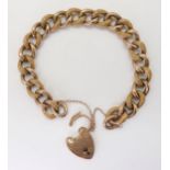 A 9CT GOLD CURB CHAIN BRACELET with heart-shaped clasp, hollow construction with alternate links