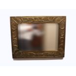 A SCOTTISH BRASS WALL MIRROR of rectangular form, decorated in relief to each corner with a