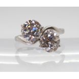 A SUBSTANTIAL TWIN STONE DIAMOND RING set with two old cut diamonds with an estimated approx diamond