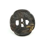 A JAPANESE GILT-BRONZE TSUBA, LIKELY 19TH CENTURY Well-patinated and of characteristic form, with