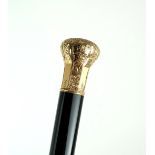A LATE-19TH/EARLY-20TH CENTURY WALKING CANE The bright yellow metal top engraved with scrolling