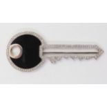 AN 18CT GOLD KEY PENDANT in the shape of a Yale style key, set with both onyx and diamonds, with