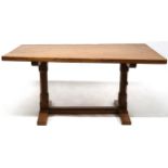 A PETER "RABBITMAN" HEAP OAK REFECTORY STYLE TABLE with adzed three plank top on octagonal column